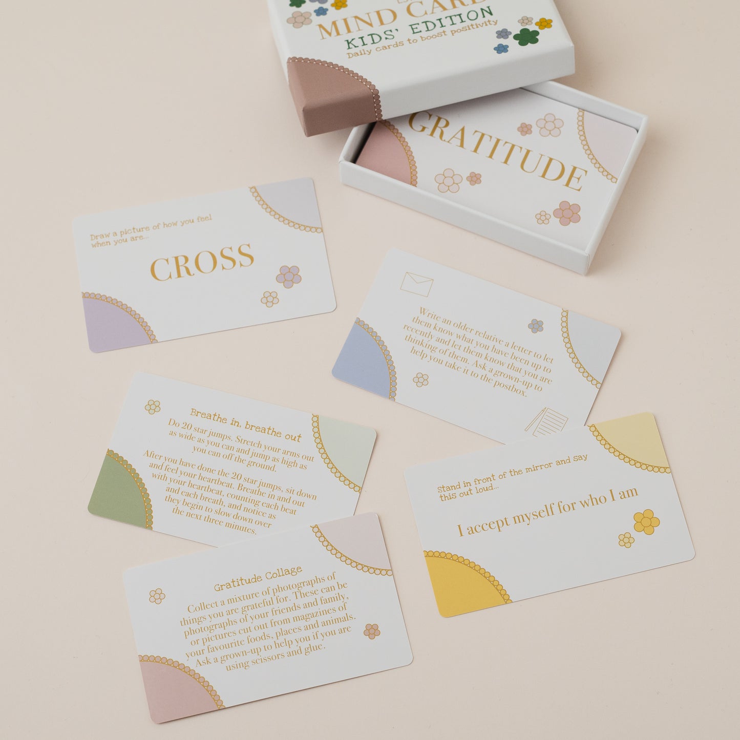 Mind Care Kids Edition card set with cards spread out on a beige surface