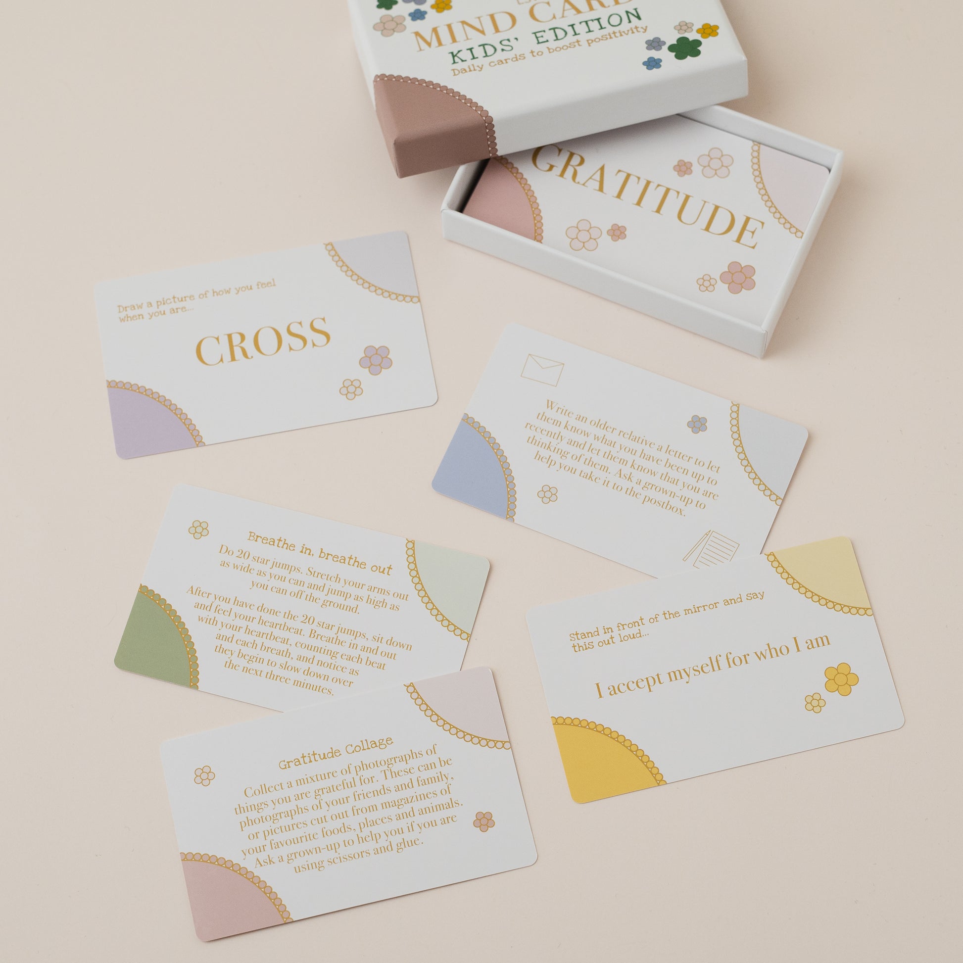 Mind Care Kids Edition card set with cards spread out on a beige surface